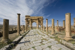 Algeria. Timgad (ancient Thamugadi or Thamugas). Decumanus street and surrounding colonnade terminated Trajan's Arch.